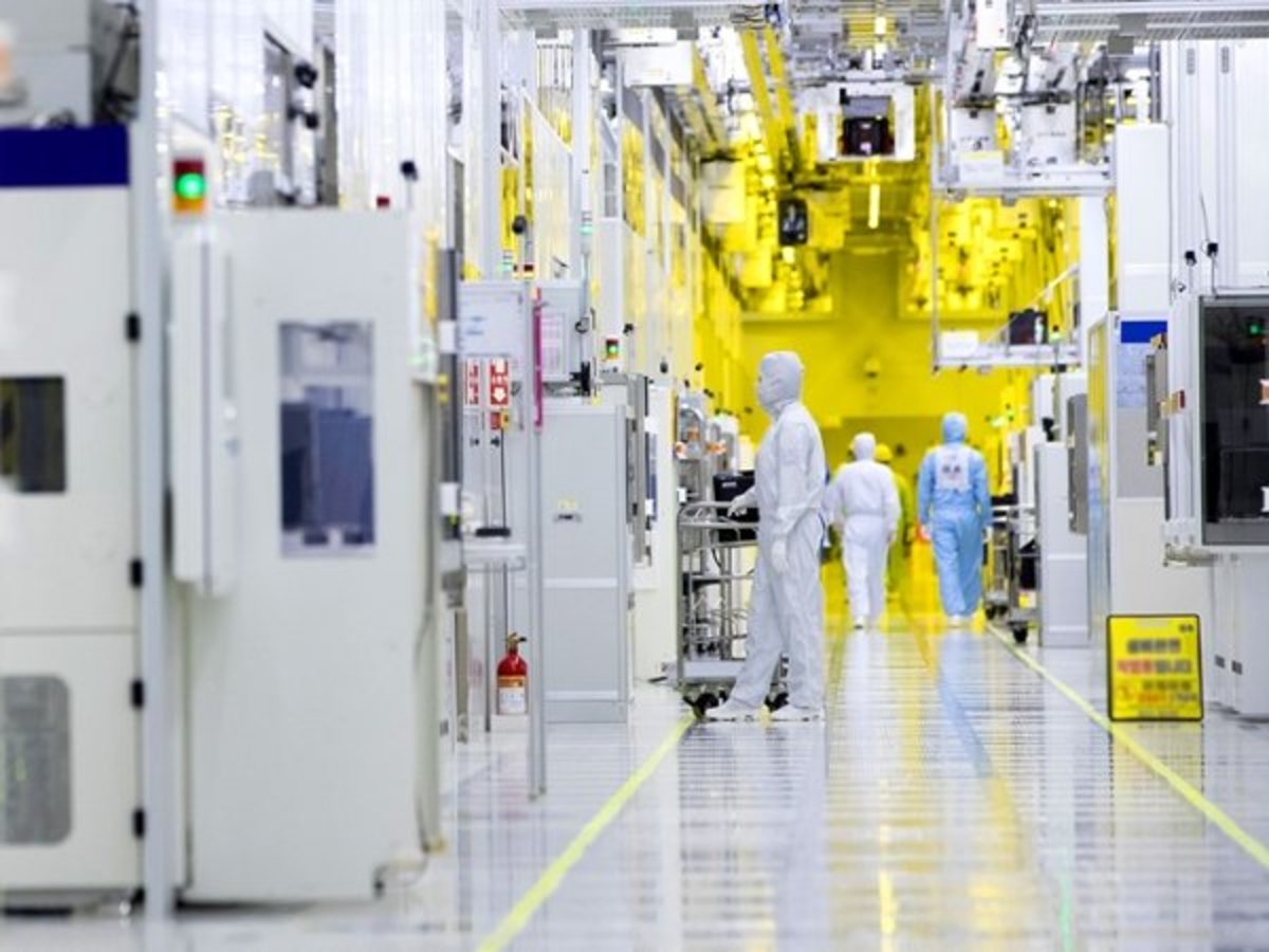 Engineers reviewing electronics production metrics